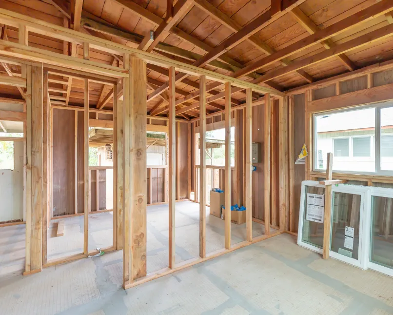 Interior wood framing of a custom backyard ADU under construction in Los Angeles showing walls, structural framing, and window openings