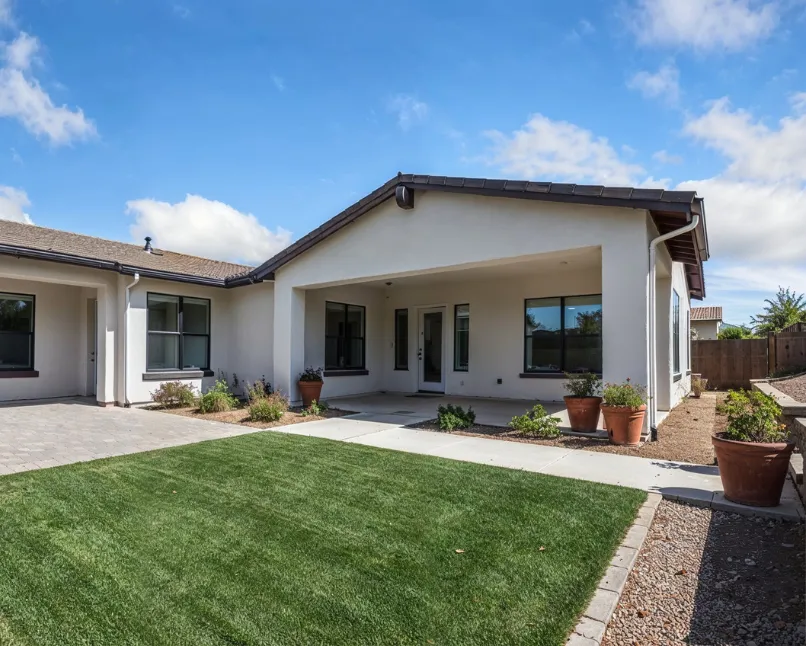 Modern junior ADU built in Los Angeles with covered patio, sliding glass doors, and landscaped backyard living space